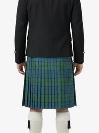 Person wearing a black jacket and green plaid kilt on a white background