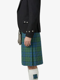 Person wearing a black blazer and green plaid kilt on a white background