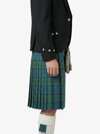 Person wearing a black jacket and green plaid kilt on a white background