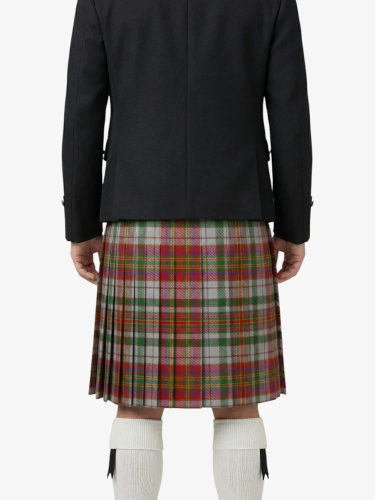 Person wearing a dark jacket and plaid kilt on a white background