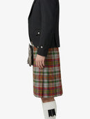 Person wearing a black jacket and red plaid kilt on a white background