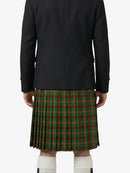 Person wearing a black jacket and green plaid kilt on a white background