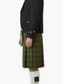 Person wearing a black jacket and green plaid kilt on a white background