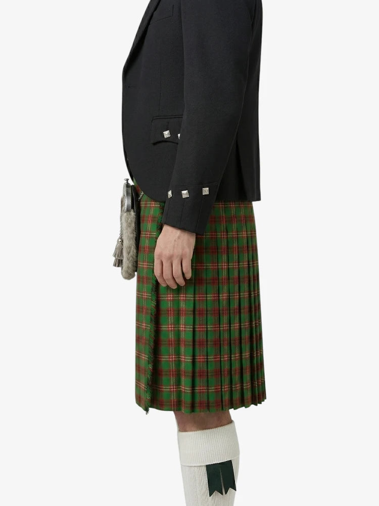 Person wearing a black jacket and green plaid kilt on a white background