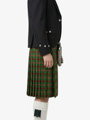 Person wearing a black jacket and green plaid kilt on a white background