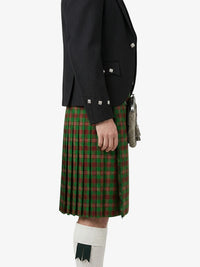 Person wearing a black jacket and green plaid kilt on a white background