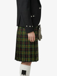 Person wearing a black jacket and green plaid kilt on a white background