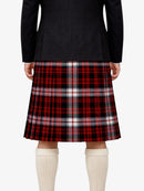 Person wearing a black jacket and red plaid kilt on a white background