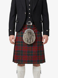 Person wearing a traditional Scottish kilt with a tartan pattern on a white background