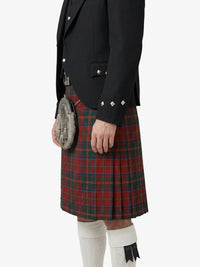 Person wearing a black jacket, red plaid kilt, and white knee-high socks on a white background