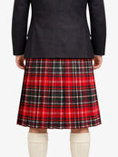 Person wearing a black jacket and red plaid kilt on a white background