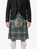 Person wearing a traditional Scottish kilt with a jacket on a white background