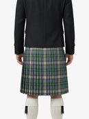 Person wearing a black jacket and plaid kilt on a white background
