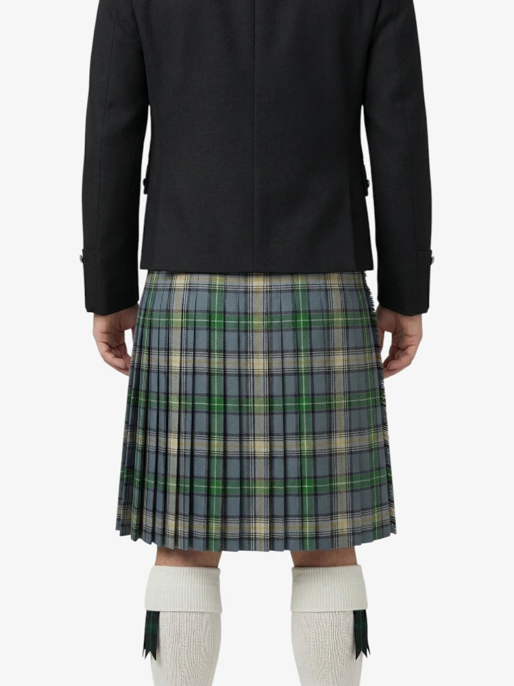 Person wearing a black jacket and plaid kilt on a white background