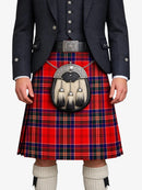 Person wearing a red tartan kilt with a black jacket on a white background