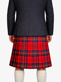 Person wearing a dark gray jacket and red plaid kilt on a white background