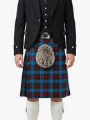 Person wearing a traditional Scottish kilt with a patterned sporran on a white background