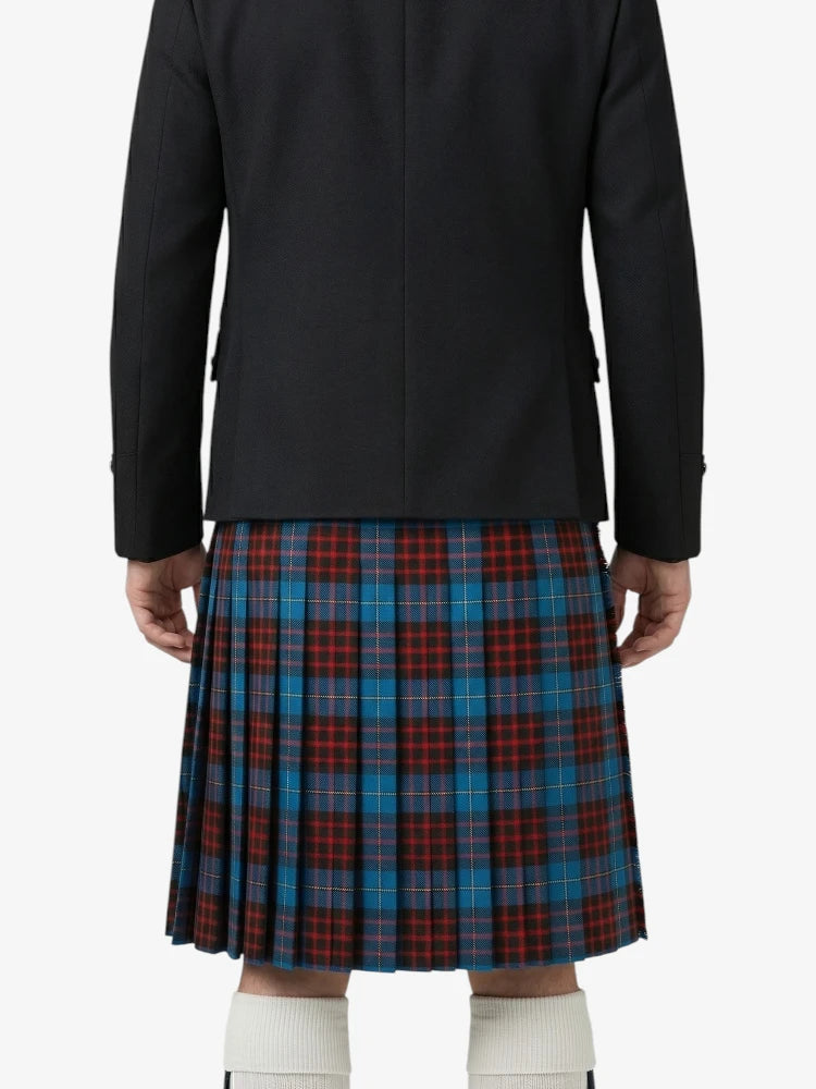 Person wearing a black jacket and a red, blue, and green plaid kilt on a white background