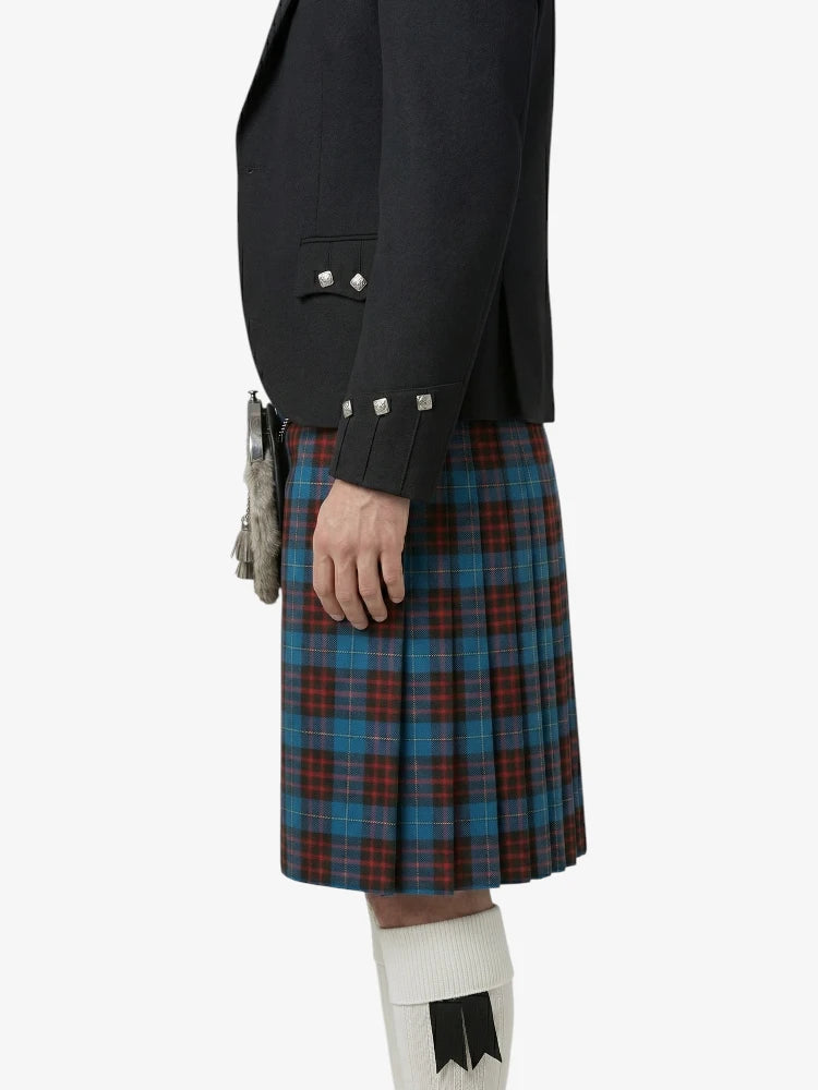Person wearing a black jacket and a plaid kilt on a white background
