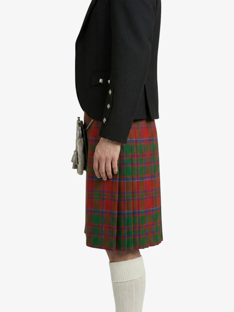Person wearing a black jacket and red plaid kilt on a white background