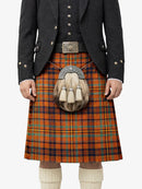 Person wearing a traditional Scottish kilt with a jacket and sporran on a white background
