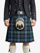 Person wearing a traditional Scottish kilt with a tartan pattern on a white background