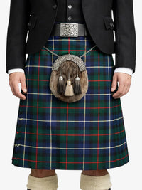 Person wearing a traditional Scottish kilt with a tartan pattern on a white background