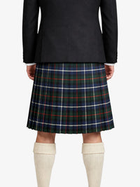 Person wearing a black jacket and plaid kilt on a white background