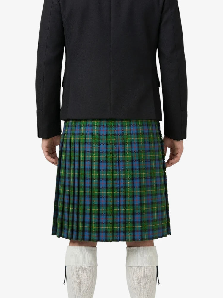 Person wearing a black jacket and green plaid kilt on a white background