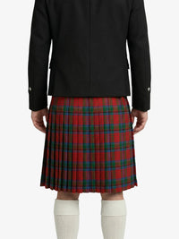 Person wearing a black coat and red plaid kilt on a white background