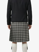 Person wearing a black jacket and plaid kilt on a white background