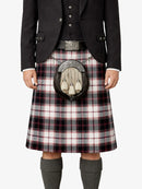 Person wearing a Scottish kilt with a sporran on a white background