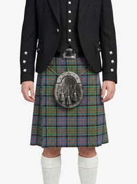Person wearing a traditional Scottish kilt with a jacket on a white background