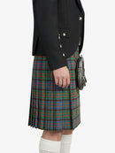 Person wearing a black blazer and plaid kilt on a white background