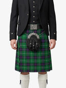 Person wearing a green plaid kilt with a black jacket on a white background