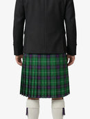 Person wearing a black coat and green plaid kilt on a white background