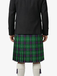 Person wearing a black coat and green plaid kilt on a white background