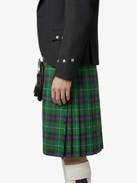Person wearing a green plaid kilt with a black jacket on a white background