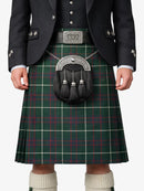 Person wearing a green plaid kilt with a dark jacket and white socks.
