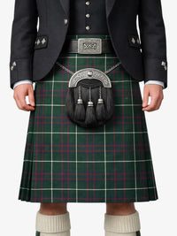 Person wearing a green plaid kilt with a dark jacket and white socks.