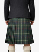 Person wearing a dark jacket and green plaid kilt on a white background