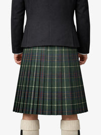 Person wearing a dark jacket and green plaid kilt on a white background
