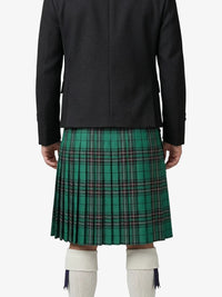 Person wearing a black jacket and green plaid kilt on a white background