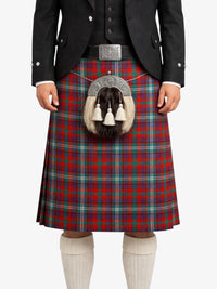 Person wearing a traditional Scottish kilt with a tartan pattern on a white background