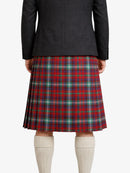 Person wearing a black jacket and red plaid kilt on a white background