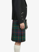 Person wearing a black jacket and green plaid kilt on a white background