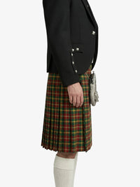 Person wearing a black blazer and plaid kilt on a white background