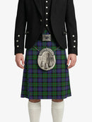 Person wearing a traditional Scottish kilt with a tartan pattern on a white background