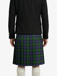 Person wearing a black coat and a plaid kilt on a white background