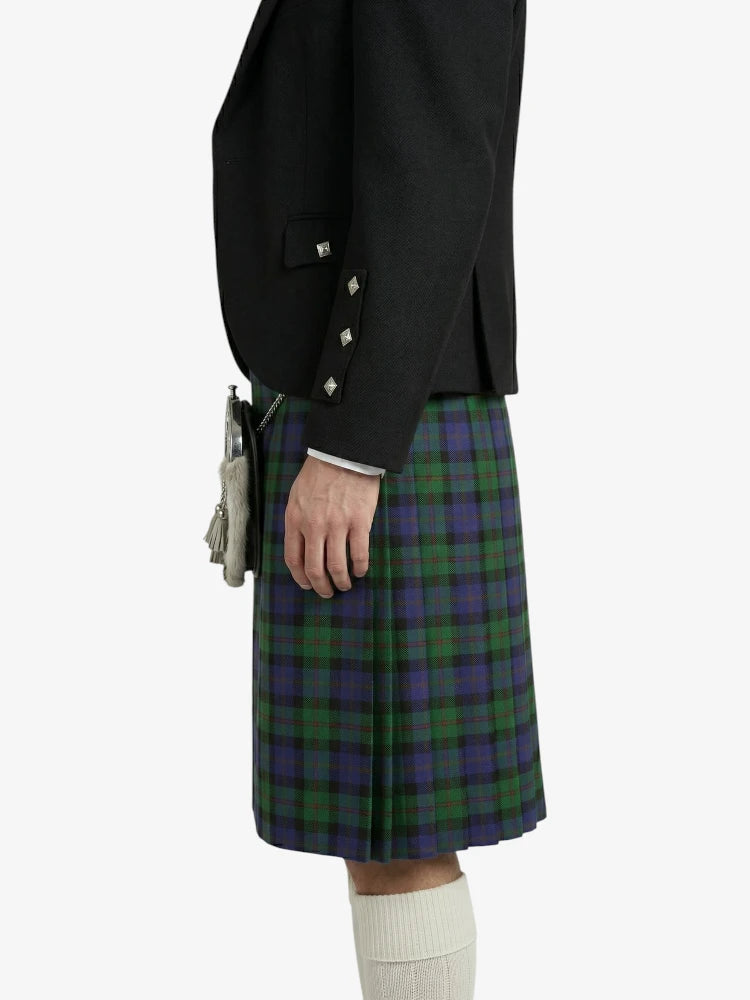 Person wearing a black jacket and green plaid kilt on a white background